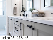 Grey bathroom vanity with white walls, mirror and marble countertop, black hardware. Clean aesthetic background. Home interior room design. Gray cabinet in a bathroom. Стоковое AI-изображение, AI-художник Марина Демидюк / Фотобанк Лори