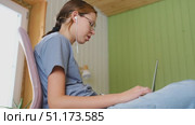 Teen girl school student wear headphones watching online webinar, talking through webcam looking at laptop. Teenager conducting video conference on computer at home, chatting online with friends. 4K. Стоковое видео, видеограф Марина Демидюк / Фотобанк Лори