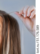 Salon hair extension procedure with each strand carefully prepared by professional hairstylist for perfect results. Стоковое фото, фотограф Svetlana Golovco / Фотобанк Лори