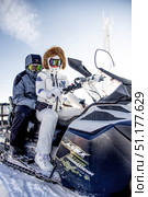 Sheregesh, Russia, 7 January 2017, Snowboarders skiers sit on snowmobile. Редакционное фото, фотограф Spirit River / Фотобанк Лори