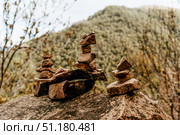 Small stones stacked in pyramids on large cobblestones, zen balance in nature. Стоковое фото, фотограф Spirit River / Фотобанк Лори