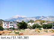 Chamyuva, Turkey - September 07, 2024: Scenic view of white buildings against mountain backdrop. Редакционное фото, фотограф Наталья Семкина / Фотобанк Лори