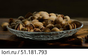 Roasted pistachios nuts in plate on dark background. Стоковое фото, фотограф Маргарита Кирьякова / Фотобанк Лори