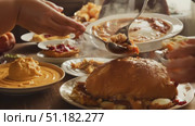 Gathered for a heartwarming meal featuring a variety of homemade dishes in an inviting autumn setting. Стоковое AI-видео, аниматор Данила Большаков / Фотобанк Лори