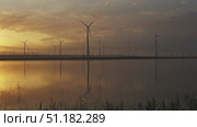 Windmills turbines with sunrise reflection. Стоковое видео, видеограф Михаил Коханчиков / Фотобанк Лори