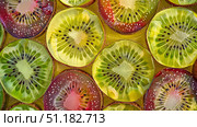 "Kiwi Kaleidoscope: Lush Greens and Radiant Golds in a Fruit Symphony. Стоковое AI-изображение, AI-художник Konstantin Plotnikov / Фотобанк Лори