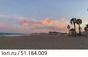 Sunset over quiet sandy beach with palm trees and colorful sky, ideal for travel background. Стоковое видео, видеограф Анастасия Золотницкая / Фотобанк Лори