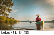 Active woman wearing a hat is seen paddling a canoe on a calm body of water. The woman is skillfully navigating the canoe with precise strokes, moving gracefully through the water. Стоковое AI-видео, аниматор Данила Большаков / Фотобанк Лори