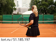 Teenage Girl Practices Her Tennis Skills on an Outdoor Court in a Vibrant Setting. Стоковое фото, фотограф Aleksandr Golubev / Фотобанк Лори