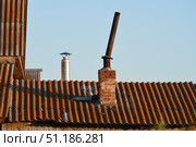 The chimney on the old house. An iron pipe and a slate roof. Стоковое фото, фотограф Valeriy Lushchikov / Фотобанк Лори