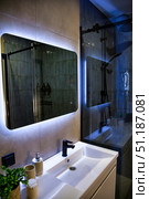 Soft Glow Radiates in Modern Bathroom With Illuminated Mirror And Shower. Стоковое фото, фотограф Aleksandr Golubev / Фотобанк Лори
