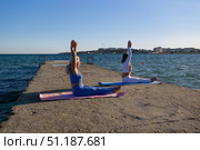 Yoga, Beach, Women - Two women practicing yoga on a pier by the sea. Стоковое фото, фотограф svetograph / Фотобанк Лори