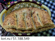 Freshly baked Azerbaijani bread flatbread churek in wicker basket on the table. Стоковое фото, фотограф Spirit River / Фотобанк Лори