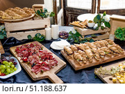 Buffet hotel restaurant, coffee break event food on wooden plates stand on table. Стоковое фото, фотограф Spirit River / Фотобанк Лори