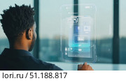 A person interacts with advanced touchscreen technology in an urban office, showcasing digital interfaces and virtual controls. Стоковое AI-видео, аниматор Данила Большаков / Фотобанк Лори