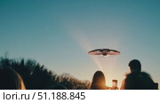 A remarkable sight unfolds as two individuals gaze upward, captivated by an unusual object hovering in the starry night sky. Стоковое AI-видео, аниматор Данила Большаков / Фотобанк Лори