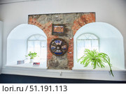 Vyborg, Russia - May 30, 2021. Museum in a 17th century castle in the city of Vyborg in Russia. An old Swedish shield on the castle wall between the loophole windows. Редакционное фото, фотограф Наталия Кирсанова / Фотобанк Лори