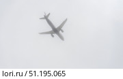 A plane is flying through a cloudy sky. Стоковое фото, фотограф Скрипачев Антон / Фотобанк Лори