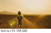 A young child joyfully runs along a deserted road, surrounded by vast desert scenery under a warm sunset glow. Стоковое AI-видео, аниматор Данила Большаков / Фотобанк Лори