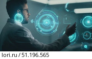 A scientist in a lab engages with advanced digital technology, analyzing data and interpreting information through an interactive display. Стоковое AI-видео, аниматор Данила Большаков / Фотобанк Лори