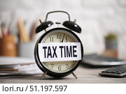 Tax season. Taxation. Text Tax Time on a Sticker, Calculator and a Clock. Paperwork, financial research, report. Calculation tax. Personal banking. Finance. Planning budget. Calculating expense. Стоковое AI-изображение, AI-художник Марина Демидюк / Фотобанк Лори