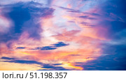Captivating sunset sky filled with vibrant hues of orange, pink, and purple, creating a dramatic and serene atmosphere. Wispy clouds enhance the beauty of the evening sky. Стоковое фото, фотограф Ольга Ильина / Фотобанк Лори