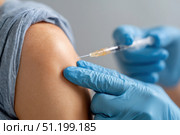 Doctor making a vaccination. Cropped of man receiving vaccine shot. Hands injecting coronavirus vaccine syringe to arm muscle of patient. Covid 19 immunization. Mpox, Dengue fever, Chikungunya. CHIKV. Стоковое AI-изображение, AI-художник Марина Демидюк / Фотобанк Лори