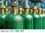 Green oxygen tanks. Bundle of gas cylinder and high pressure gauges, meter, valve. Many argon cylinders with compressed gas for industry, welding. Fuel manufacturing. Liquefied gas production, factory. Стоковое AI-изображение, AI-художник Марина Демидюк / Фотобанк Лори