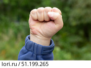 A raised clenched fist. Protests in the city. A concept. Стоковое фото, фотограф Александр Поташев / Фотобанк Лори