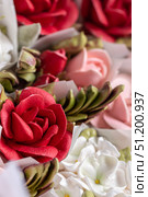 Vibrant home-made zephyr floristry featuring intricate red and pink floral designs, showcasing delicate textures and artistic craftsmanship in a visually appealing arrangement. Стоковое фото, фотограф Ирина Ручушкина / Фотобанк Лори