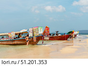 Krabi Province, Thailand - January 11, 2014: Colorful food boat at a tropical beach in Thailand serving various dishes. Редакционное фото, фотограф Татьяна  Бральнина / Фотобанк Лори
