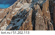 Rocky snow mountains at sunset aerial. Стоковое видео, видеограф Михаил Коханчиков / Фотобанк Лори