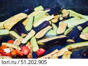 Various vegetables in a huge cauldron are cooked in oil. Стоковое фото, фотограф Наталия Кирсанова / Фотобанк Лори