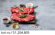 Two Fresh Raw meat Prime Black Angus Beef Steaks, Rib Eye, Denver, on wooden cutting board. Стоковое фото, фотограф Ирина Буракова / Фотобанк Лори