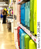 A row of colorful suitcases are on display in a store.  Russia. Moscow. 24.08.25. Редакционное фото, фотограф Ярославский Максим / Фотобанк Лори