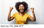 Excited African American Woman Celebrating Success in Front of White Wall. Generative AI. Стоковое AI-изображение, AI-художник Roman Zavorotny / Фотобанк Лори