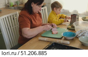 Grandma teaching grandson to make pizza dough. Happy Caucasian granny and grandchild making pizza in kitchen. Cute boy cooking together with grandmother. Family leisure. Multi generation family video. Стоковое видео, видеограф Марина Демидюк / Фотобанк Лори