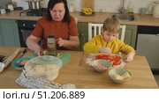 Grandma teaching grandson to make pizza dough. Happy Caucasian granny and grandchild making pizza in kitchen. Cute boy cooking together with grandmother. Family leisure. Multi generation family video. Стоковое видео, видеограф Марина Демидюк / Фотобанк Лори