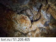 A wild cave inside. Stalactites and stalagmites. Speleology and surveys. Стоковое фото, фотограф Наталия Кирсанова / Фотобанк Лори