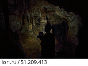 A wild cave inside. Stalactites and stalagmites. Speleology and surveys. Стоковое фото, фотограф Наталия Кирсанова / Фотобанк Лори