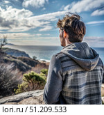 Man Contemplating Hopeful Horizon on Coastal Clifftop. Generative AI. Стоковое AI-изображение, AI-художник Roman Zavorotny / Фотобанк Лори