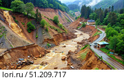 Landslide Damage Along A Winding Mountain Road. Generative AI. Стоковое AI-изображение, AI-художник Roman Zavorotny / Фотобанк Лори