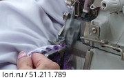 a seamstress scribbles clothes for dolls on a typewriter and smoothes it with an iron. Стоковое видео, видеограф Алексей Сергеев / Фотобанк Лори