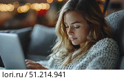 A young woman types quietly on her laptop, engrossed in her work while sitting comfortably on a sofa under soft ambient lights in the evening. Стоковое AI-видео, аниматор Данила Большаков / Фотобанк Лори