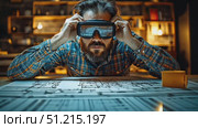 A man explores virtual reality technology as he studies intricate architectural plans in a modern workspace filled with warm lighting. Стоковое AI-видео, аниматор Данила Большаков / Фотобанк Лори
