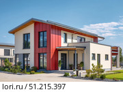 House Exterior. Roof Window. Second floor among blue sky. Mansard attic. Newly build houses. Gable roof with skylight, asphalt roofing, shingles. Residential Home. Vinyl Siding. Polymeric roof-tiles. Стоковое AI-изображение, AI-художник Марина Демидюк / Фотобанк Лори