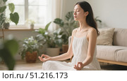 Serene young woman meditating in lotus pose on carpet at home, spiritual practice concept for mental health and finding inner calm. Стоковое AI-изображение, AI-художник Павел Муравьев / Фотобанк Лори