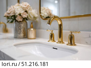 Modern golden faucet and marble stone sink. Stylish white sink, faucets in a light interior. Copper brass tap. Domestic Appliances. Clean bright bathroom. Household equipment. New Contemporary style. Стоковое AI-изображение, AI-художник Марина Демидюк / Фотобанк Лори