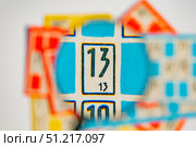 Examination of the card with numbers through the lens. Стоковое фото, фотограф Siarhei Starastau / Фотобанк Лори