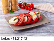 Italian Caprese salad with tomato, mozarella and pesto. Стоковое фото, фотограф Андрей Старостин / Фотобанк Лори